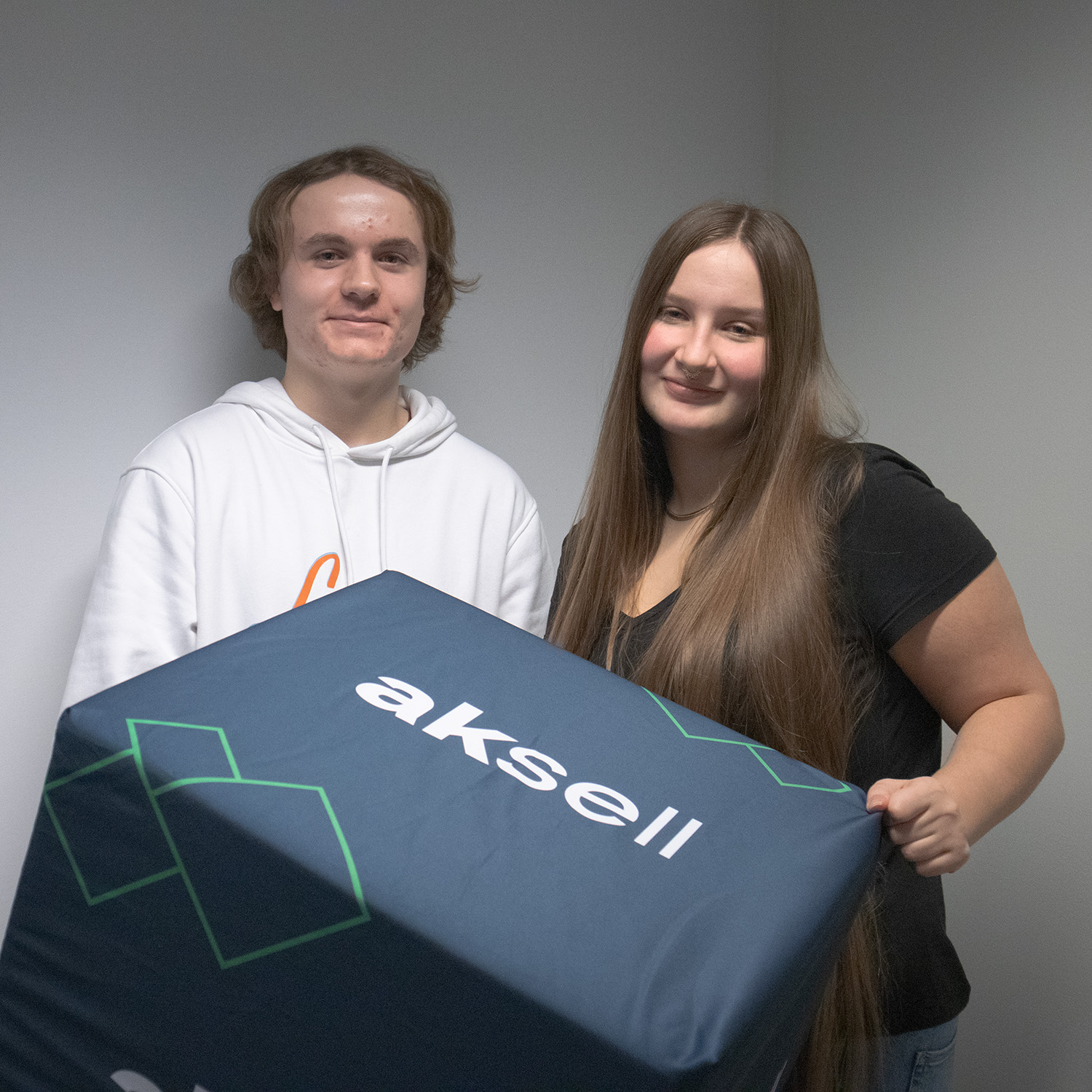 Emma Gabrielsen og Tobias Hjelle poserer med Aksell-logo